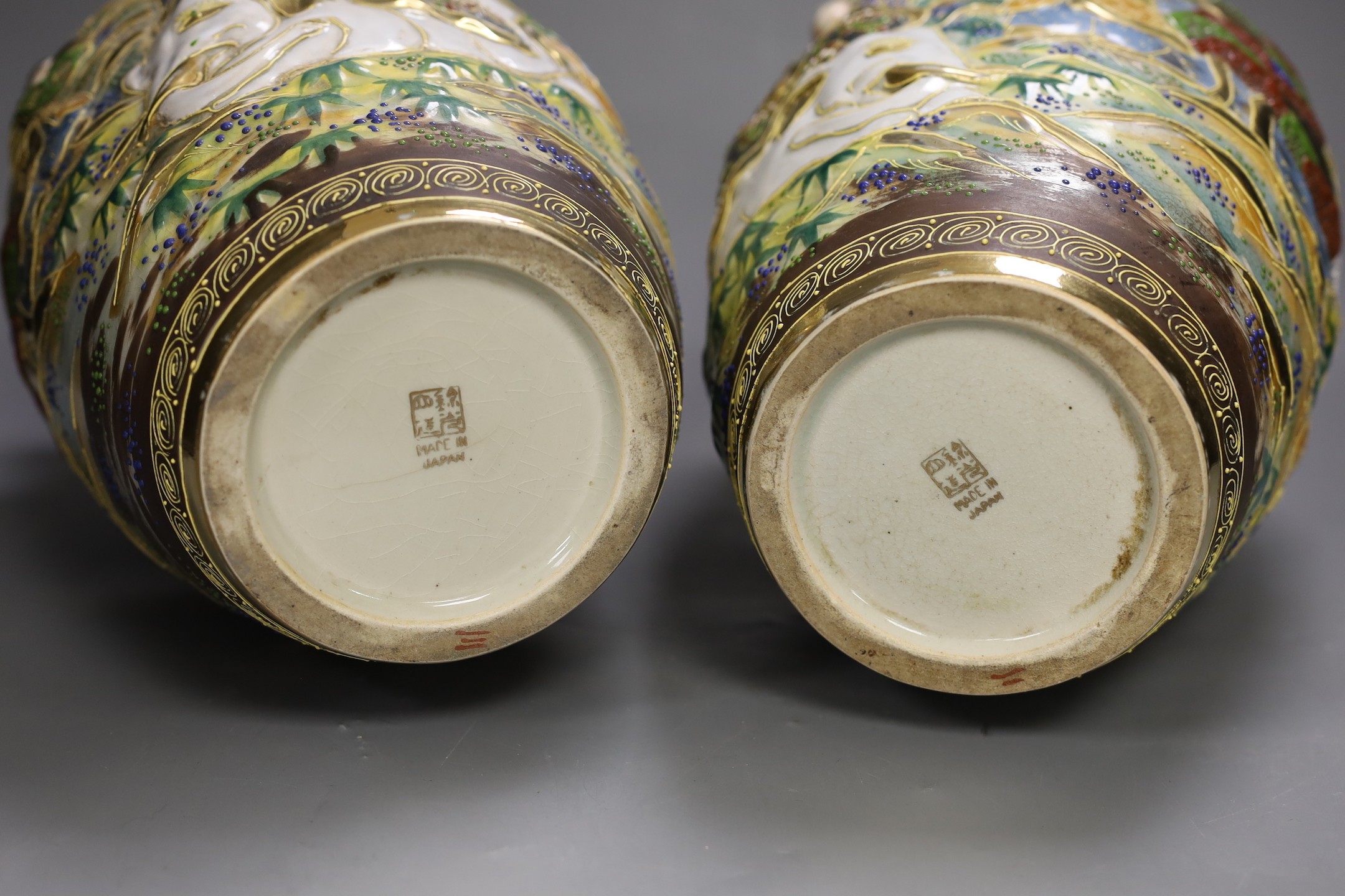A pair of Japanese moulded and moriage decorated vases, 31cms